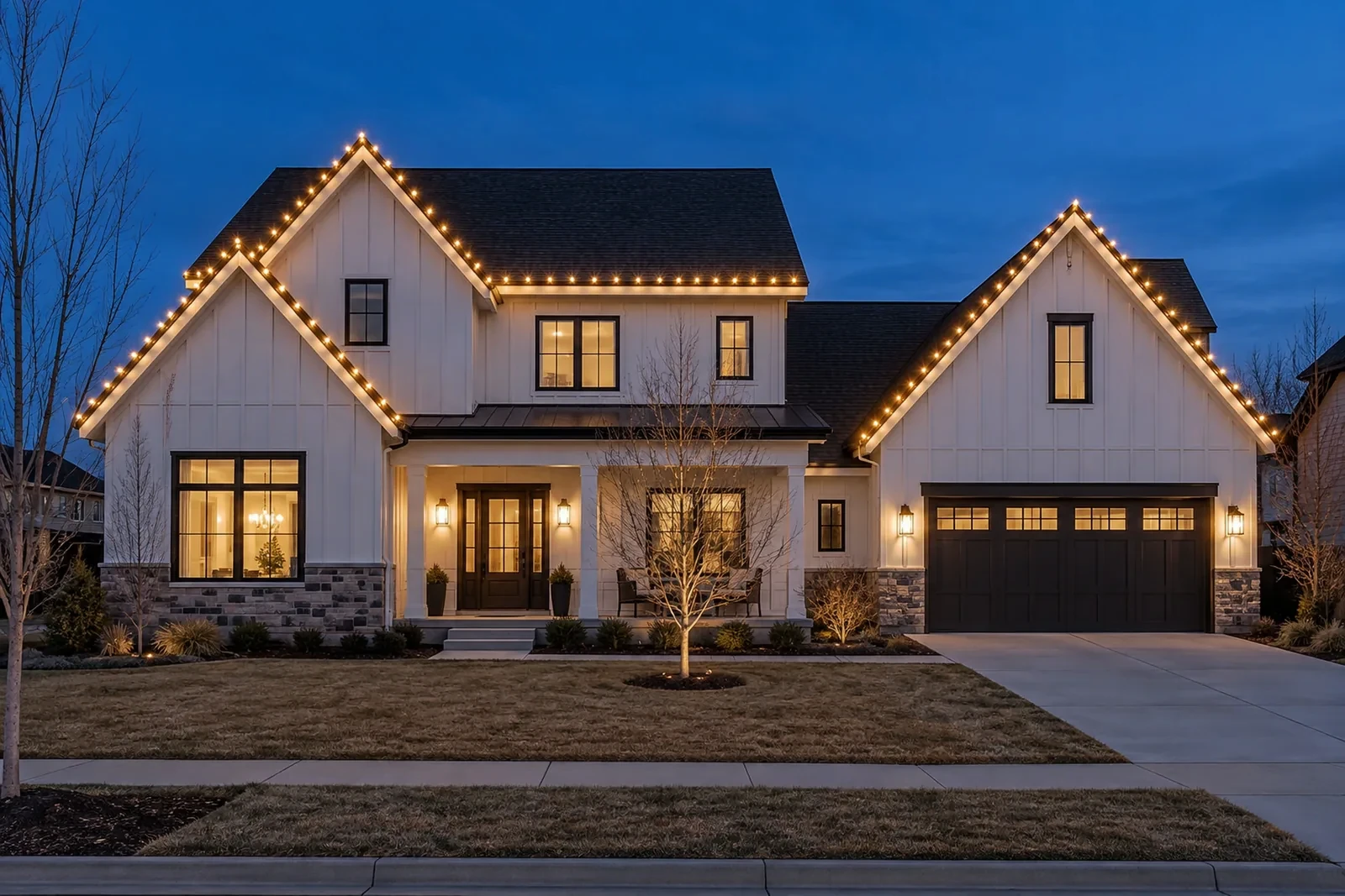 A two-story modern farmhouse with warm white lights on the roofline and both front gables